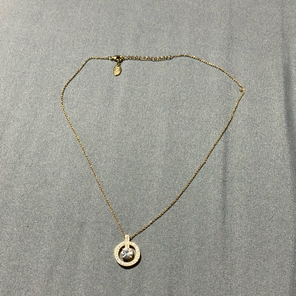 Gold tone necklace with a crystal rhinestone